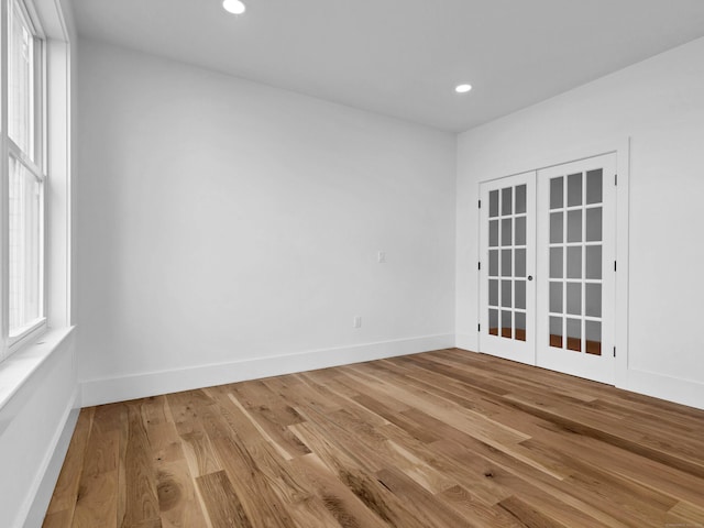 spare room featuring french doors and wood-type flooring