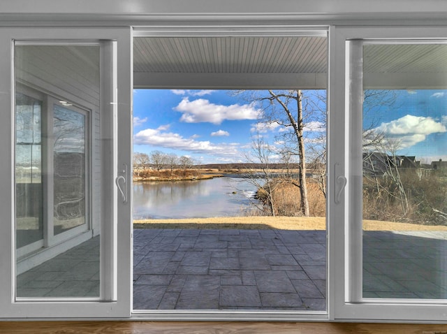 doorway to outside featuring a water view