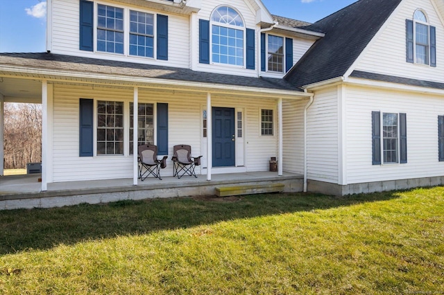 view of front of house featuring covered porch and a front lawn