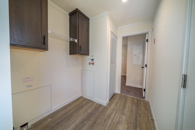 laundry room featuring cabinets, wood-type flooring, hookup for a washing machine, and ornamental molding