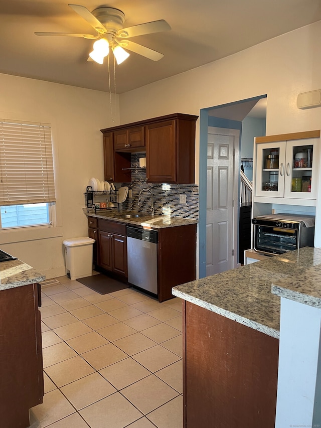 kitchen with light stone countertops, ceiling fan, dishwasher, and light tile patterned flooring