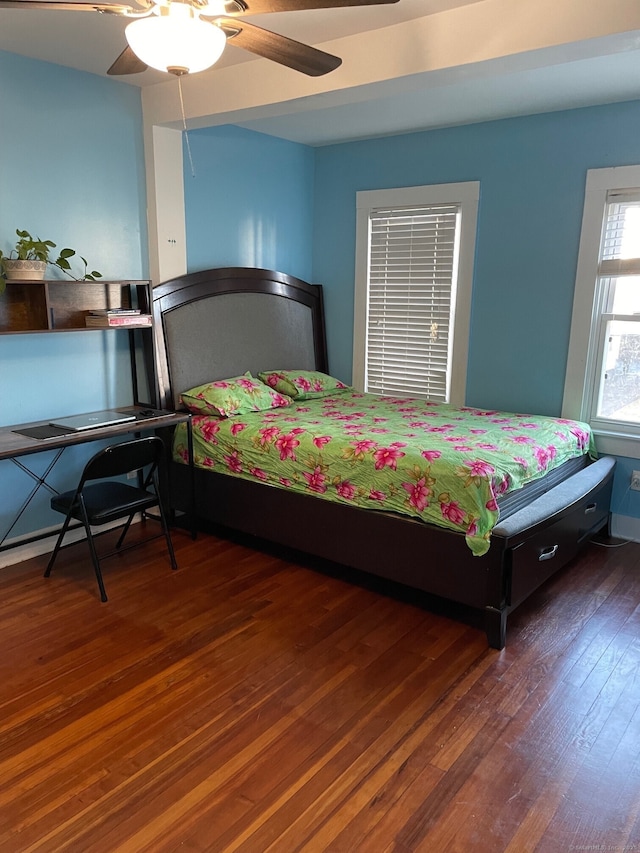 bedroom with ceiling fan and dark hardwood / wood-style flooring