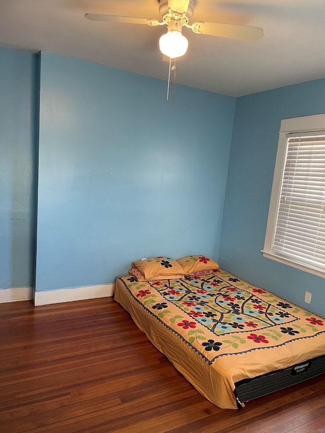 bedroom featuring ceiling fan and dark hardwood / wood-style floors