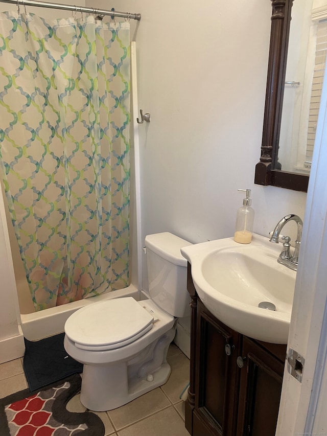 bathroom featuring curtained shower, toilet, vanity, and tile patterned flooring