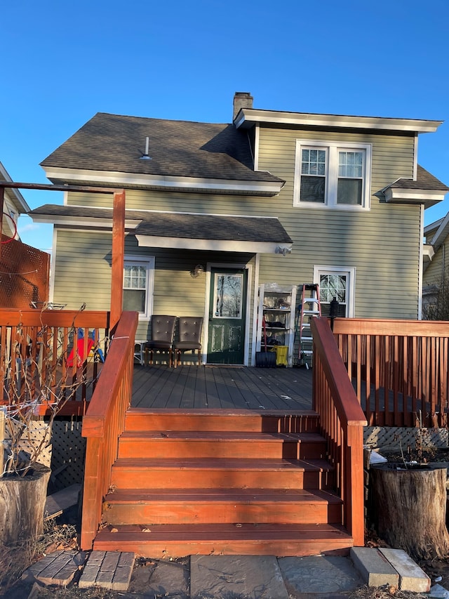 rear view of house featuring a wooden deck