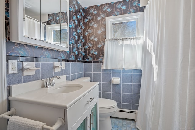 full bathroom with vanity, a baseboard radiator, wallpapered walls, tile walls, and toilet