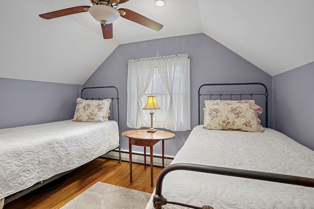 bedroom featuring lofted ceiling, wood finished floors, baseboard heating, and ceiling fan