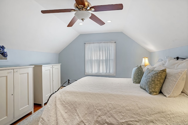 bedroom featuring lofted ceiling, wood finished floors, and a ceiling fan