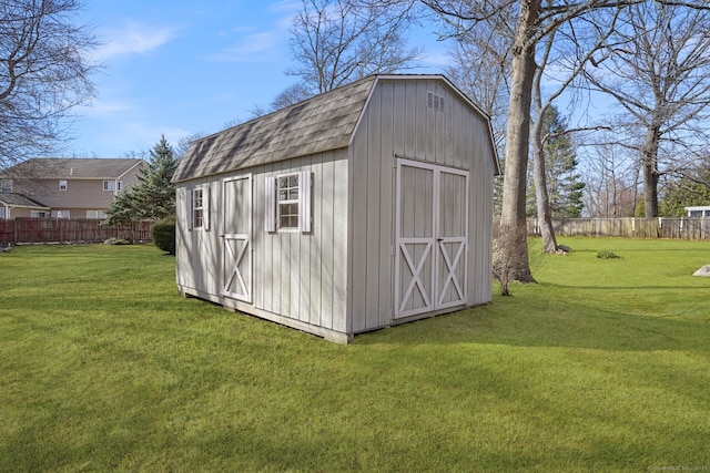 view of shed featuring fence