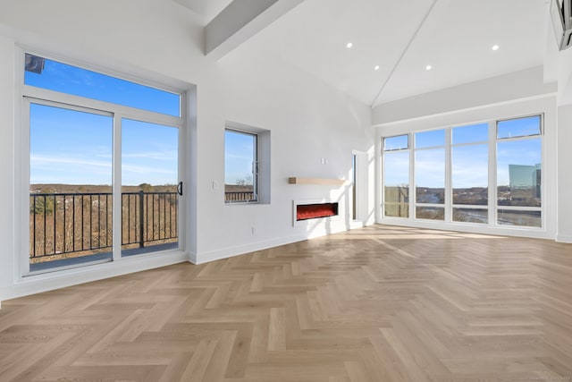 unfurnished living room with beam ceiling and light parquet floors