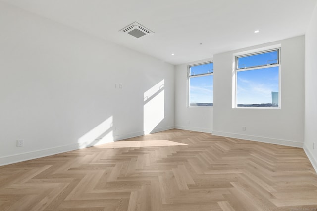 unfurnished room with light parquet floors