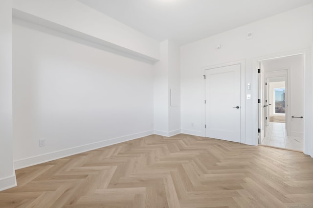 empty room with light parquet flooring