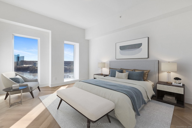 bedroom with light parquet flooring