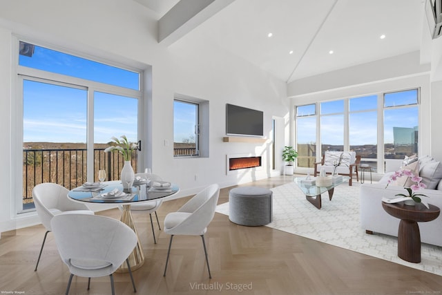 living room with beamed ceiling, high vaulted ceiling, and light parquet floors