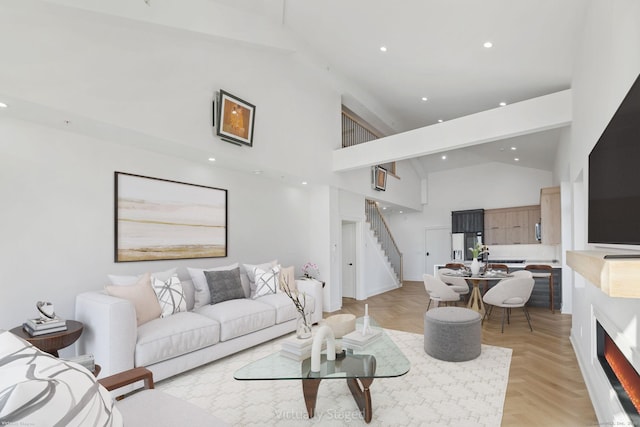 living room featuring high vaulted ceiling and light parquet floors