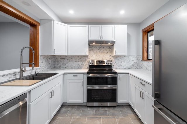 kitchen with white cabinetry, appliances with stainless steel finishes, and tasteful backsplash