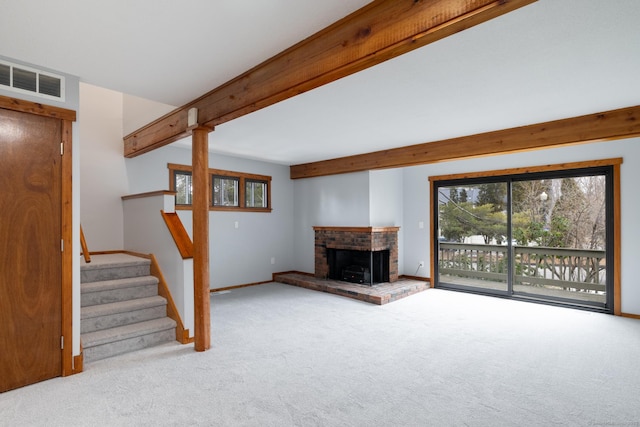 unfurnished living room featuring beam ceiling, light colored carpet, and a fireplace