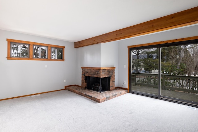 unfurnished living room with carpet, plenty of natural light, and a fireplace