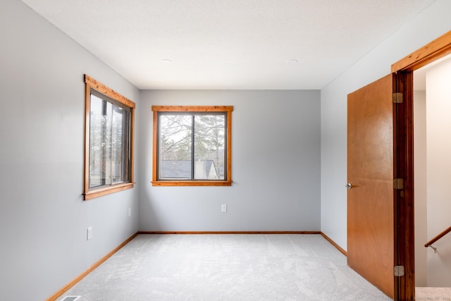 empty room with light colored carpet