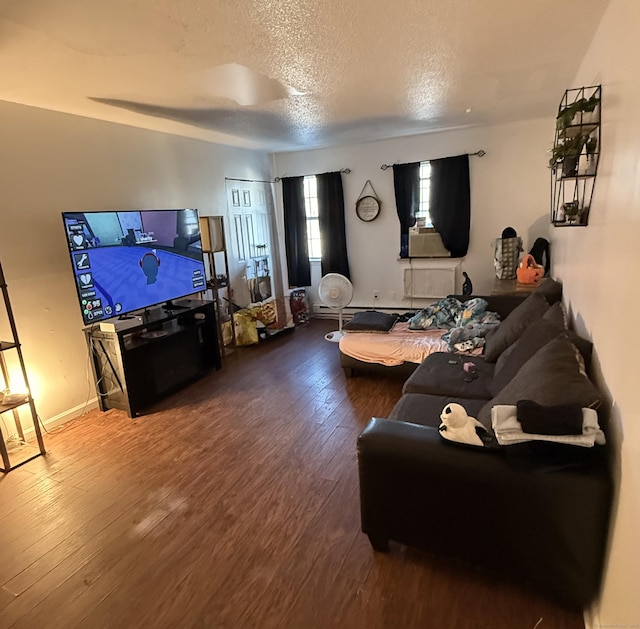 living room with hardwood / wood-style floors and a textured ceiling