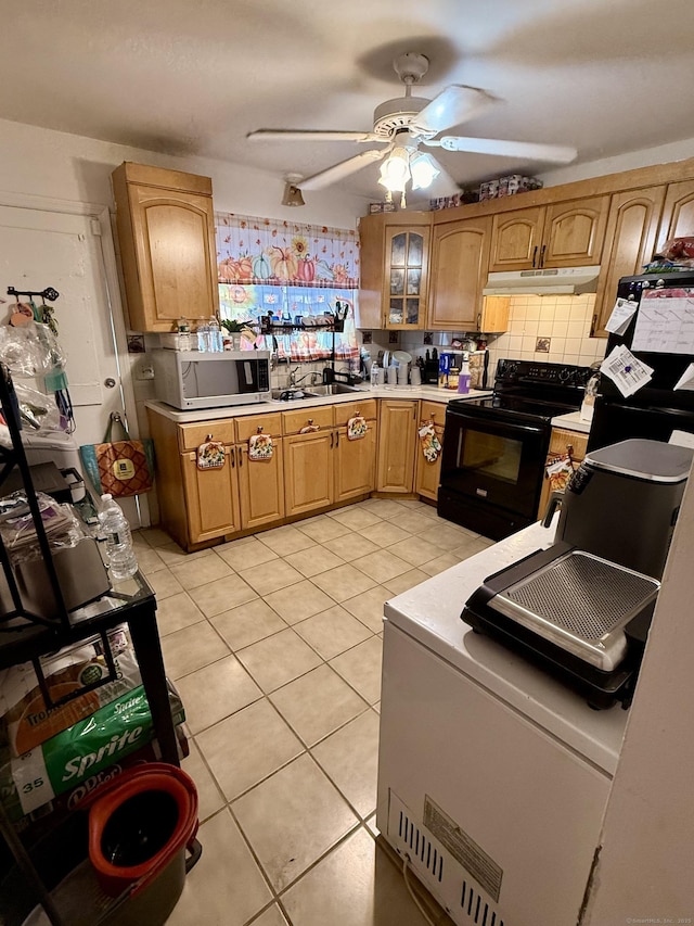 kitchen featuring ceiling fan, light tile patterned floors, sink, and black range with electric cooktop