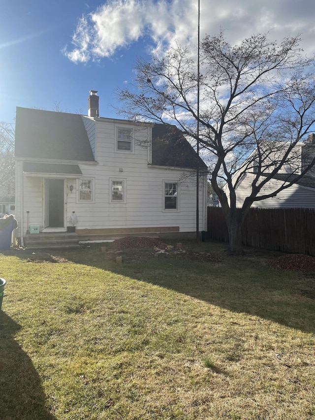 back of property featuring a lawn