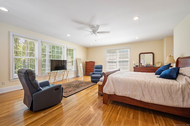 bedroom with light hardwood / wood-style floors and ceiling fan