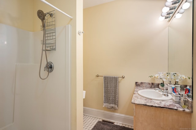 bathroom with a shower and vanity