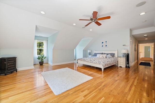 bedroom with wood-type flooring, ceiling fan, and lofted ceiling