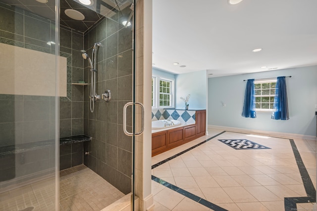 bathroom with tile patterned flooring, a wealth of natural light, and plus walk in shower