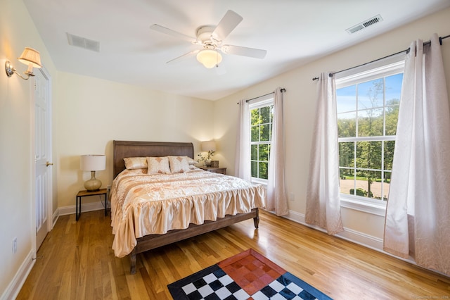 bedroom with ceiling fan and light hardwood / wood-style flooring