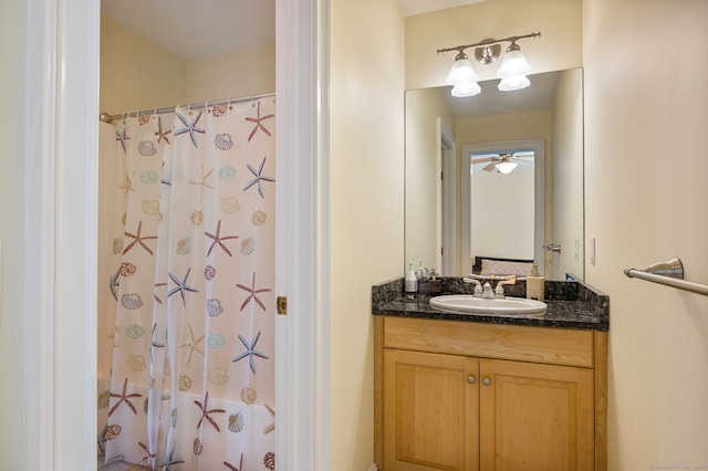 bathroom with curtained shower and vanity