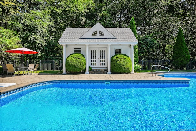 view of pool featuring a patio area and an outdoor structure