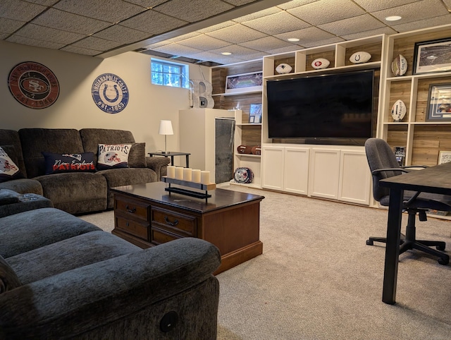 living room featuring a drop ceiling and light colored carpet