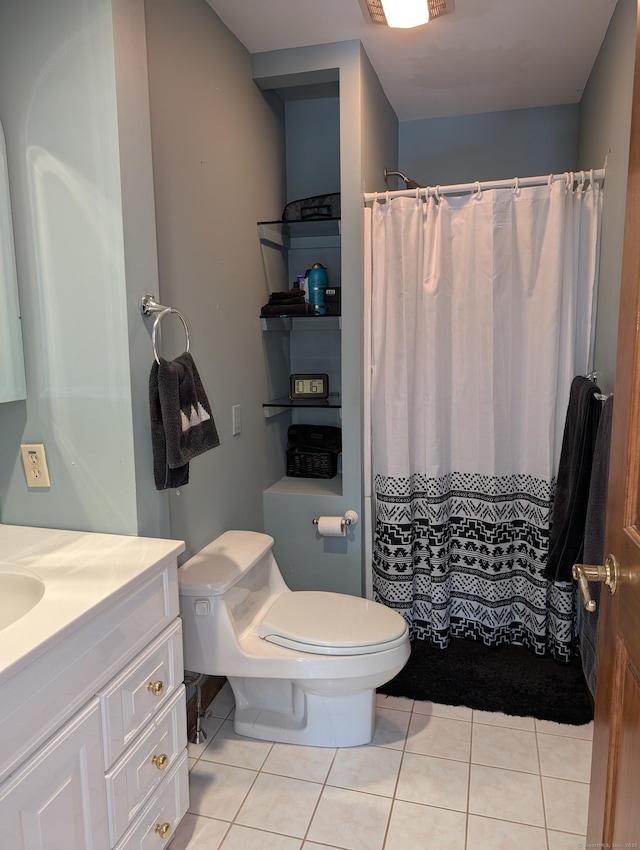 full bathroom with tile patterned flooring, a shower with shower curtain, toilet, and vanity