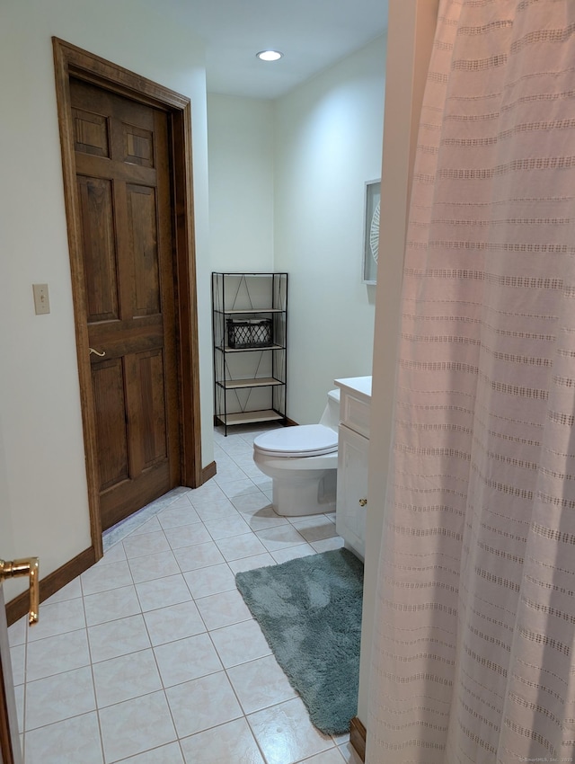 bathroom featuring vanity, baseboards, recessed lighting, tile patterned flooring, and toilet