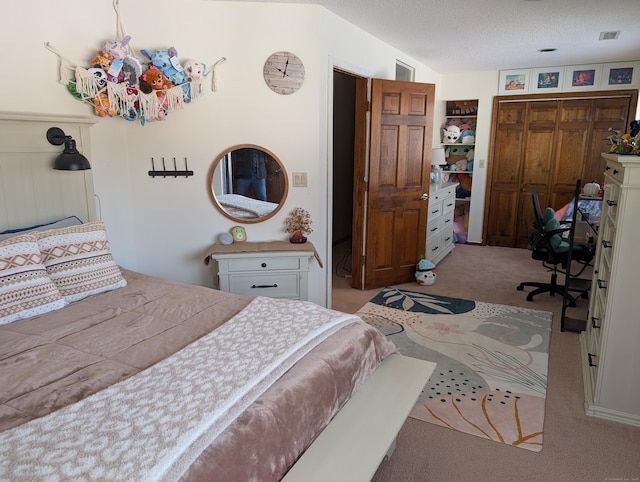 bedroom with visible vents, a textured ceiling, a closet, carpet floors, and vaulted ceiling