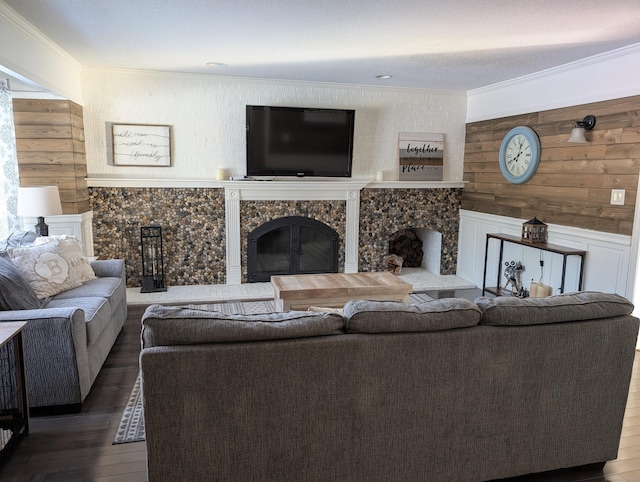 living room featuring hardwood / wood-style floors, a high end fireplace, and ornamental molding