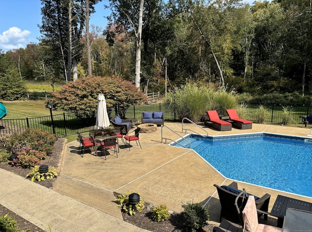 view of pool featuring a fenced in pool, a fire pit, a patio, and fence