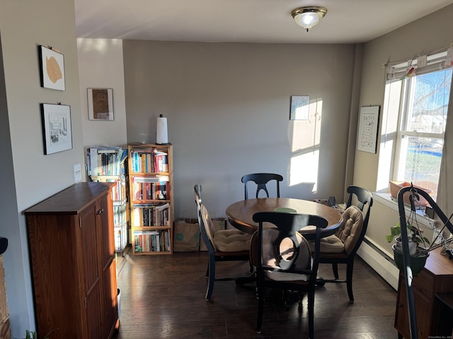 dining area featuring dark wood-type flooring and a baseboard radiator