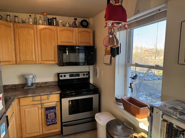 kitchen with electric range and light tile patterned floors