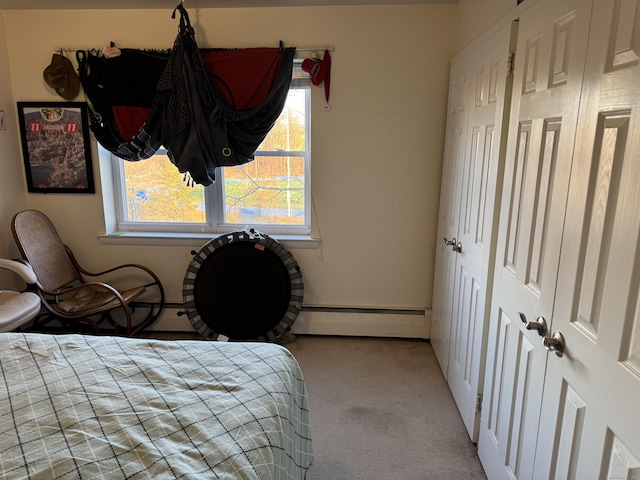 bedroom featuring baseboard heating and light colored carpet