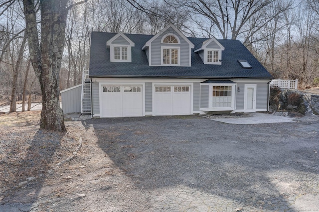 cape cod house with a garage