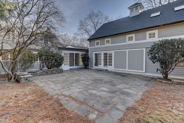 back of property with french doors and a patio