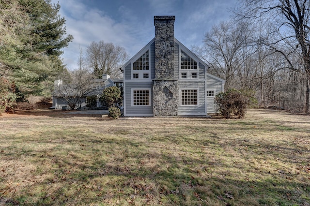 rear view of house featuring a lawn