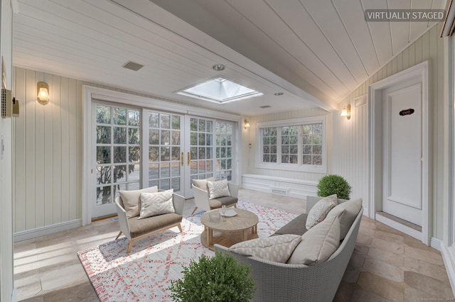 sunroom with plenty of natural light, wooden ceiling, french doors, and vaulted ceiling with skylight