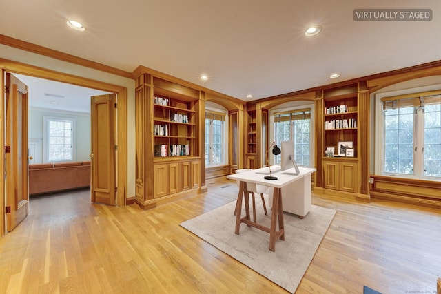 home office featuring light hardwood / wood-style floors, built in features, and ornamental molding