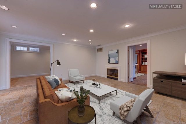 living room with stone tile floors, crown molding, and recessed lighting
