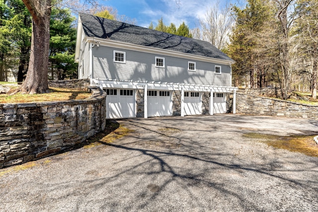 garage featuring aphalt driveway