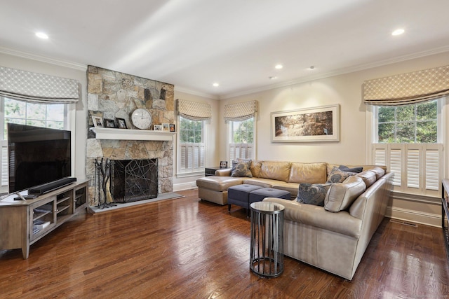 living room featuring a fireplace, ornamental molding, and dark hardwood / wood-style floors